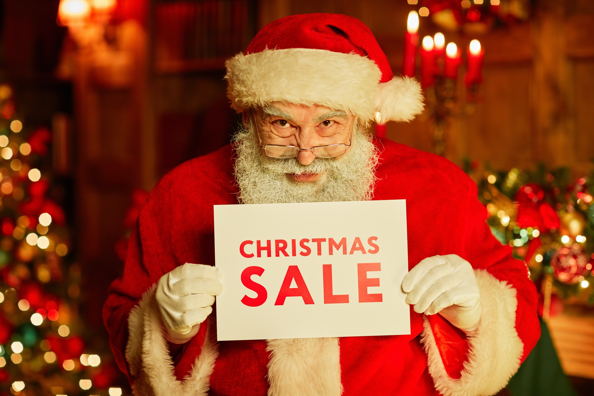 Santa Claus Holding Christmas Sale Sign